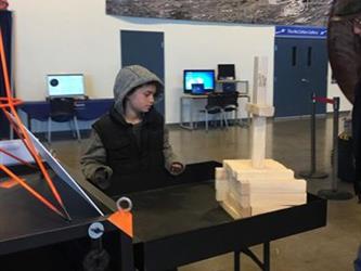 student doing an activity in a space museum