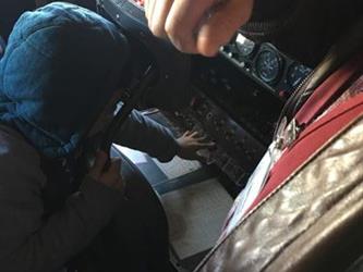 boy sitting in an airplane model in a museum