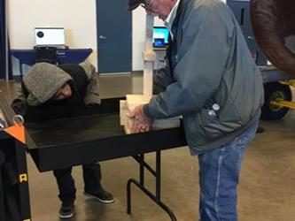 student and parent doing an activity in a space museum