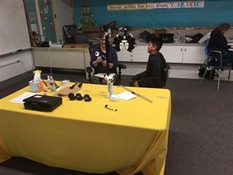 student having his vision tested in a classroom