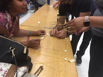 students and parents working on an activity at a table together