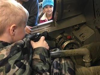 boy sitting in an airplane model in a museum