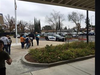 students walking outside carrying boxes