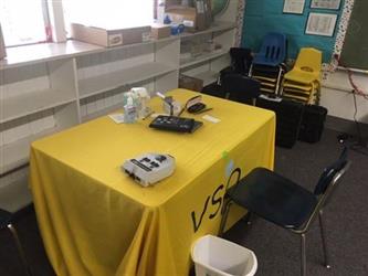 desk inside a classroom with vision testing equipment 