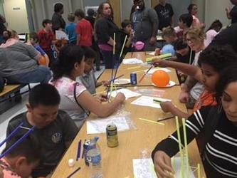 students doing an activity at a table in the cafeteria