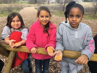 three girls working with wood outside