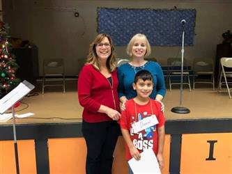 two teachers and a student smiling in the cafeteria