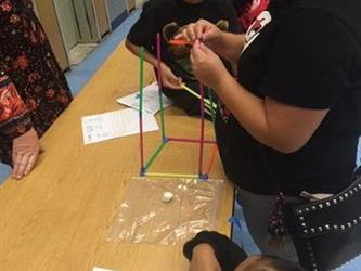 parents and students at a table working on an activity together