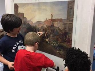 students drawing on interactive art exhibit