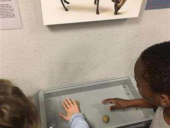 students playing with hands-on art exhibit