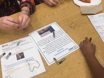 students working on an activity on a table