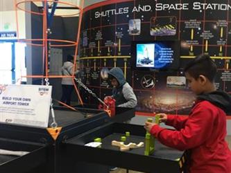 student doing an activity in a space museum