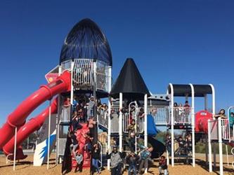 students outside on a play structure