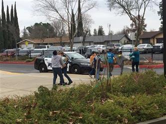 students walking outside carrying boxes